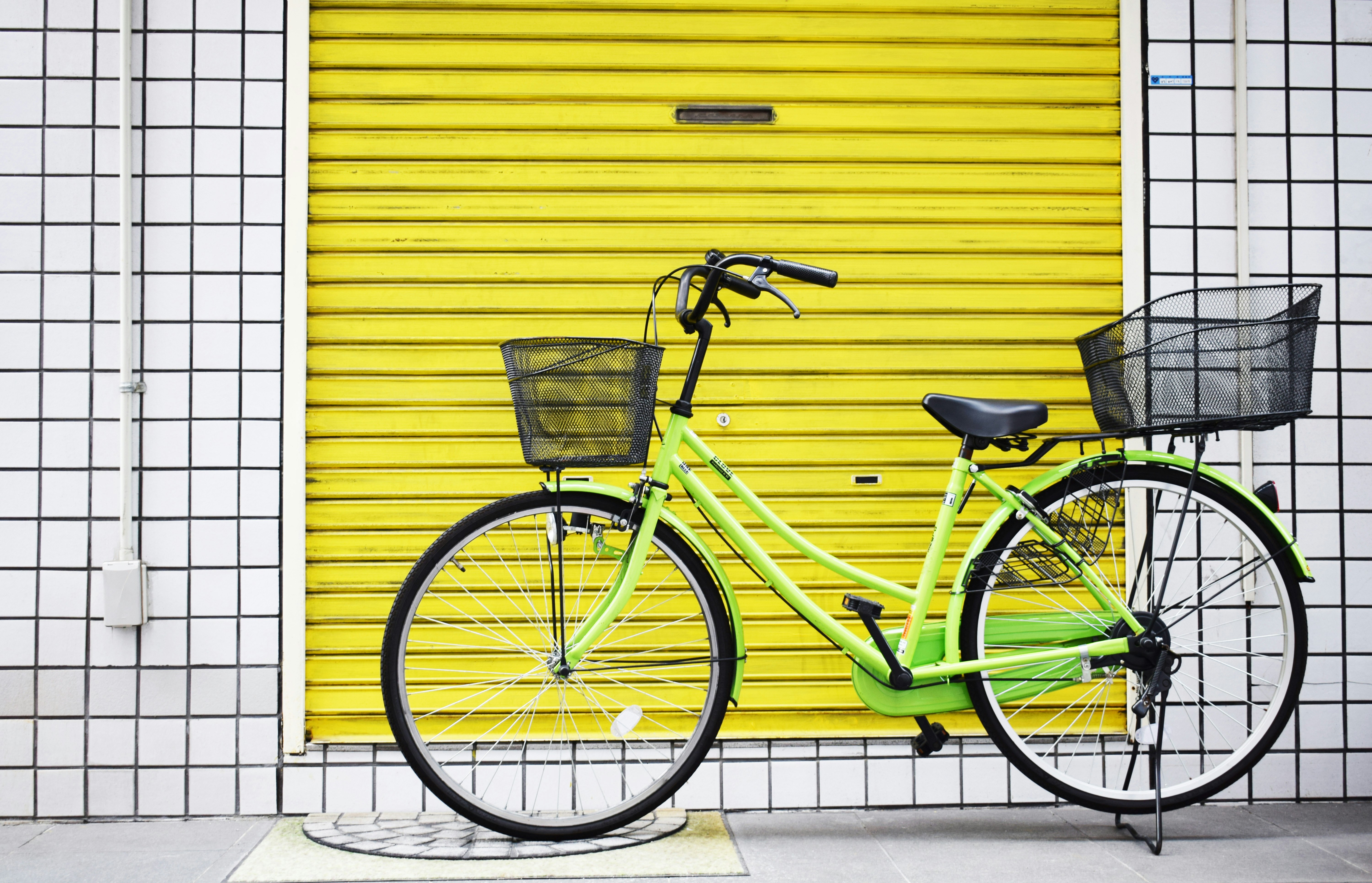 green cruiser bike near yellow gate